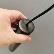 Two cylinder-shaped hanging lamps in black lacquer