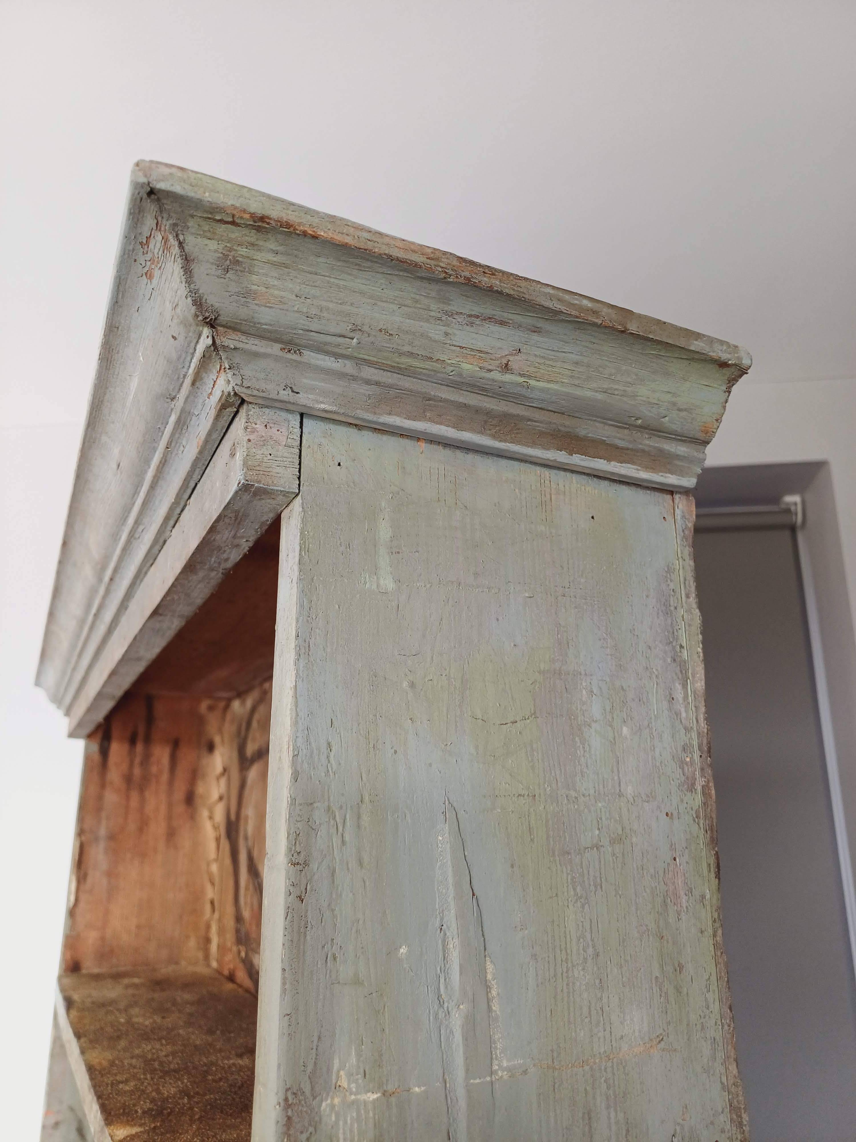 Craft cabinet with drawers with a very old tobacco advertisement in the background