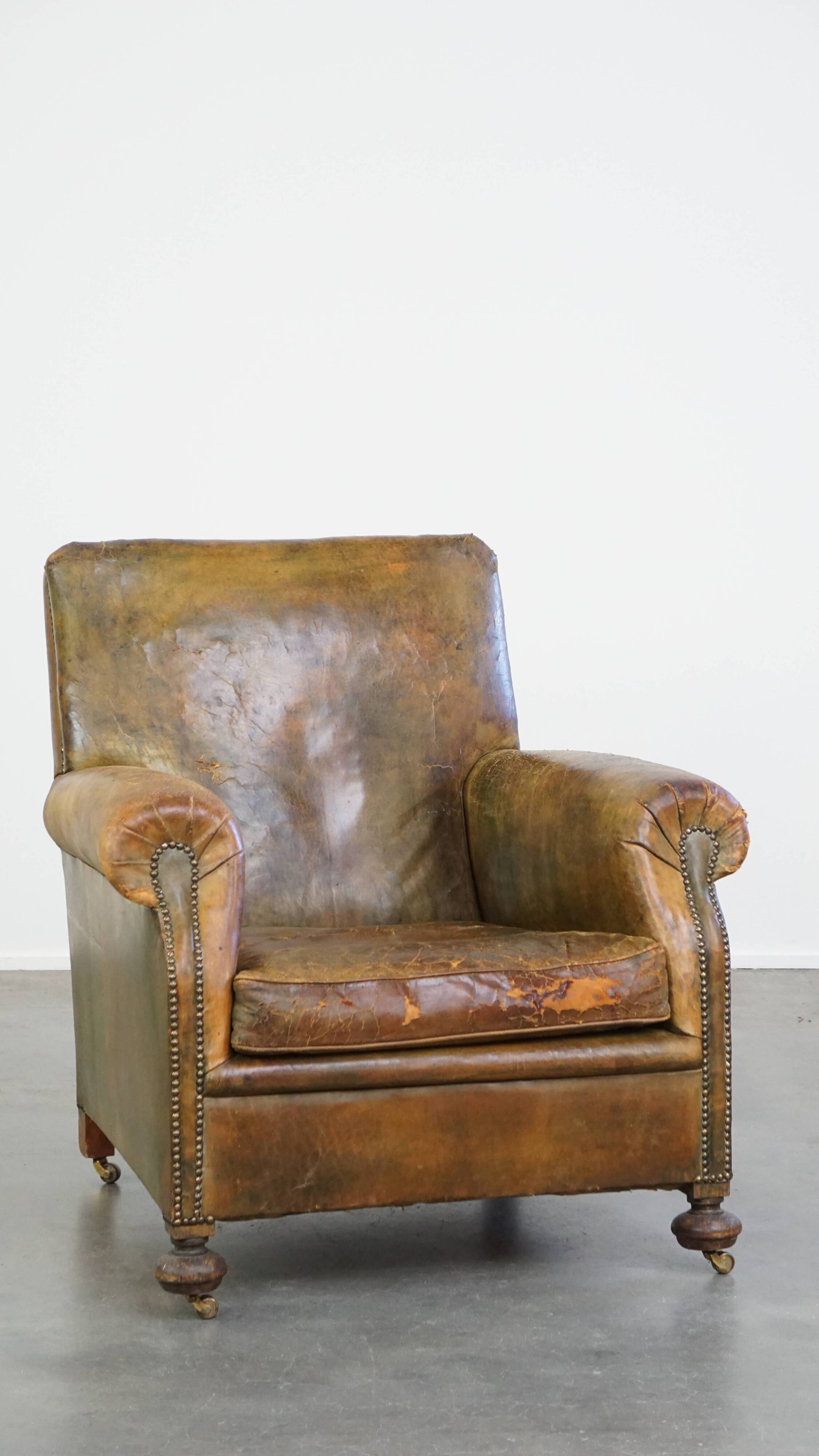 Green antique English cowhide leather armchair on wheels