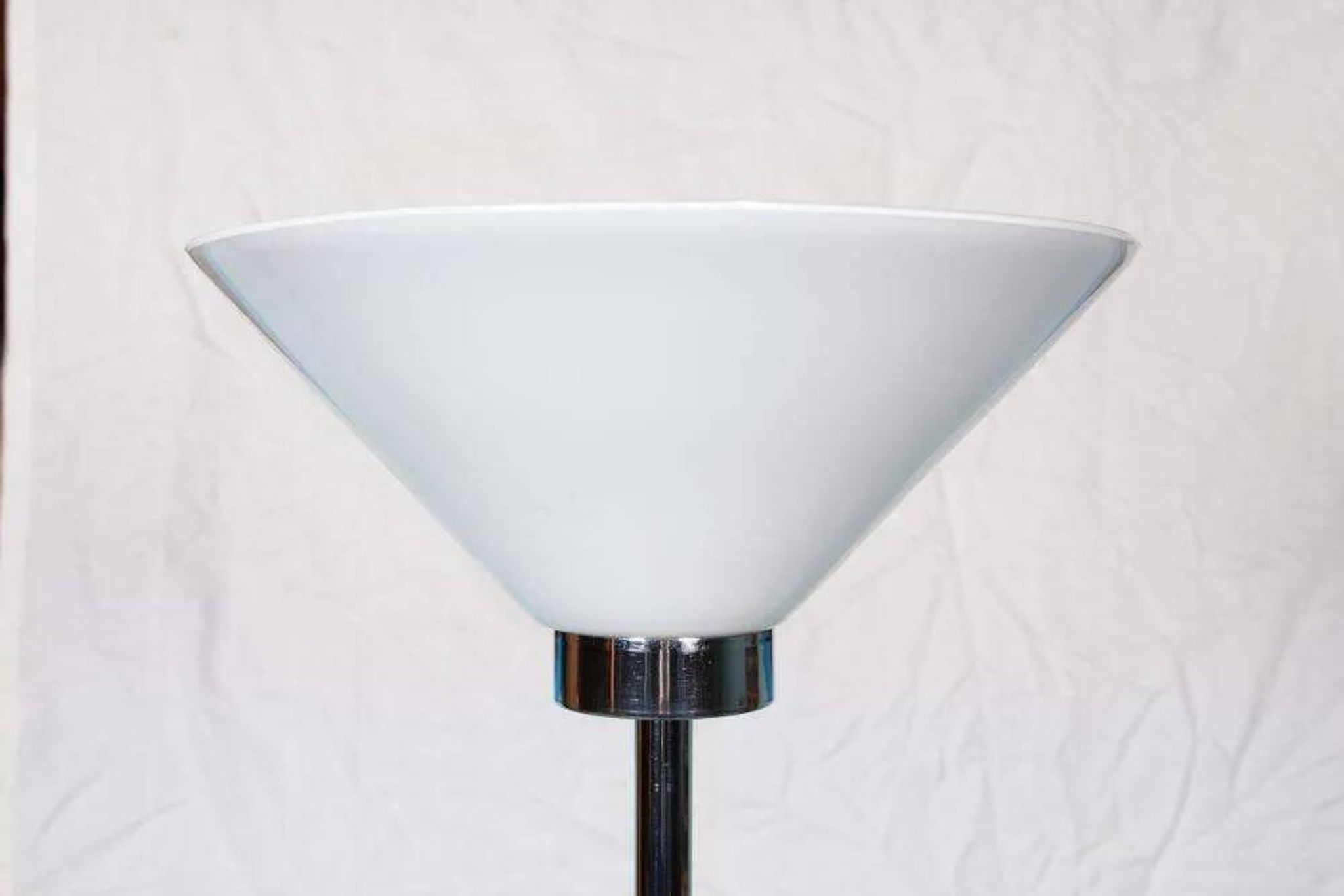 Vintage floor lamp in milky glass and chrome, minimalist uplight lighting.