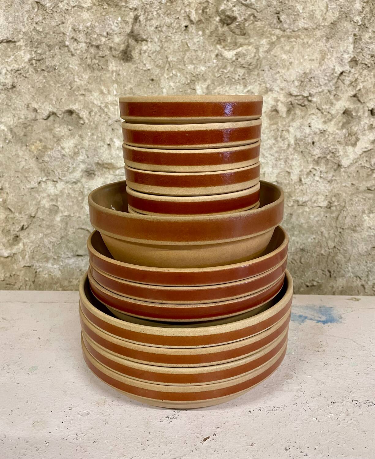 Lot of vintage Gien stoneware from France, 14 pieces including bowls and salad plates.