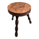 Three-legged stool with beaded wooden legs