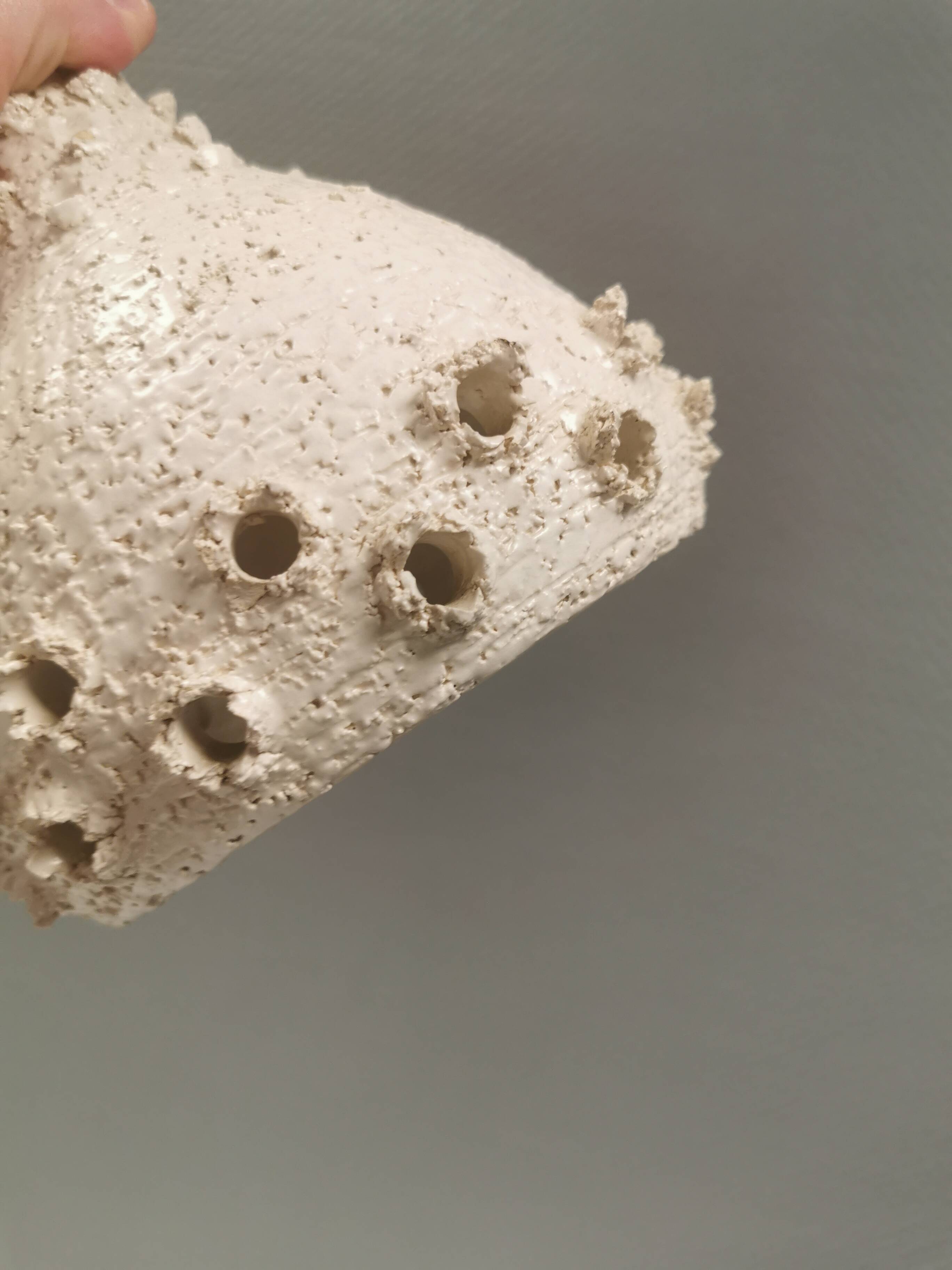 Ceramic hanging lamp in creamy white color that almost looks like a corral