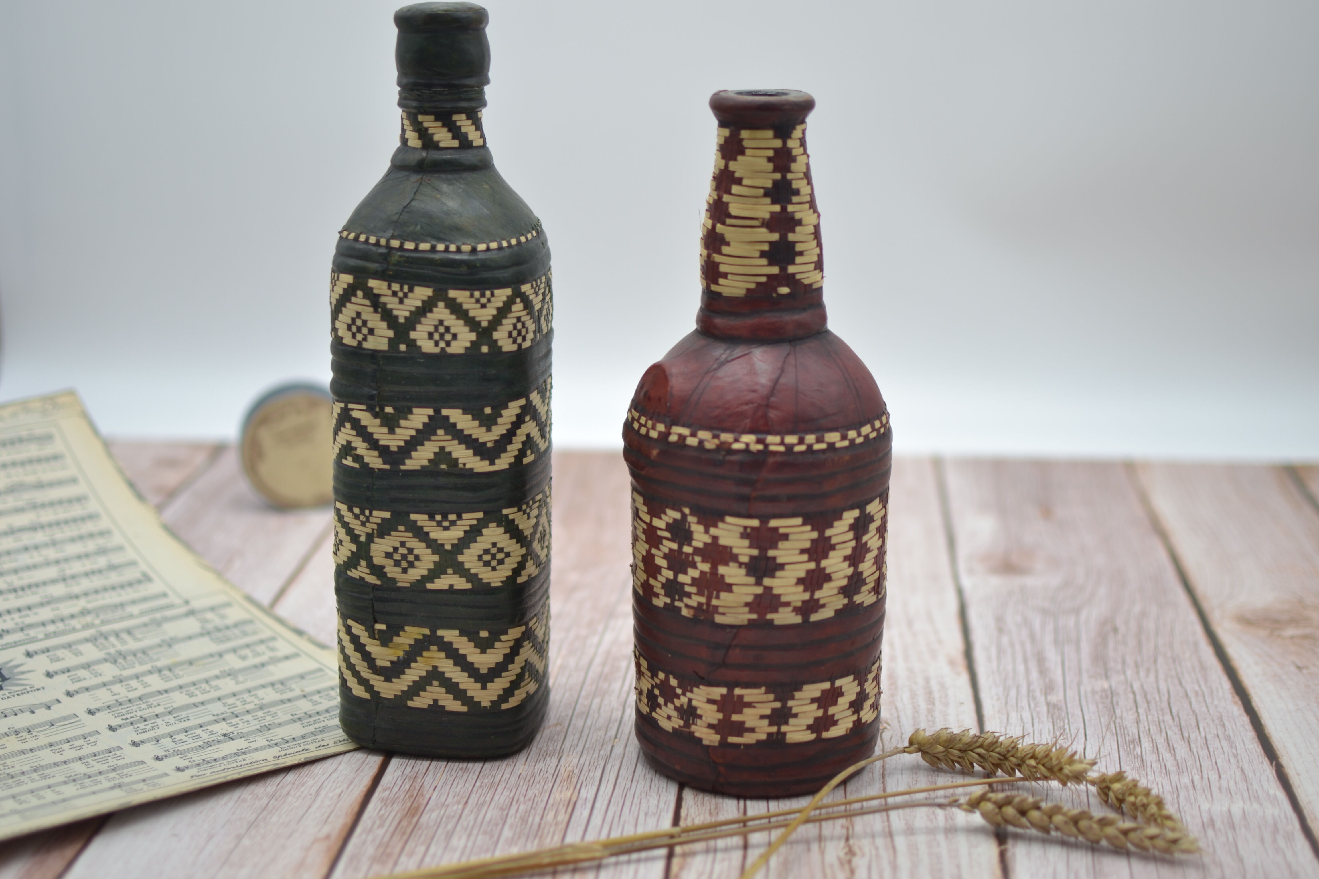 Set of 2 decorative vintage bottles covered with leather & wicker