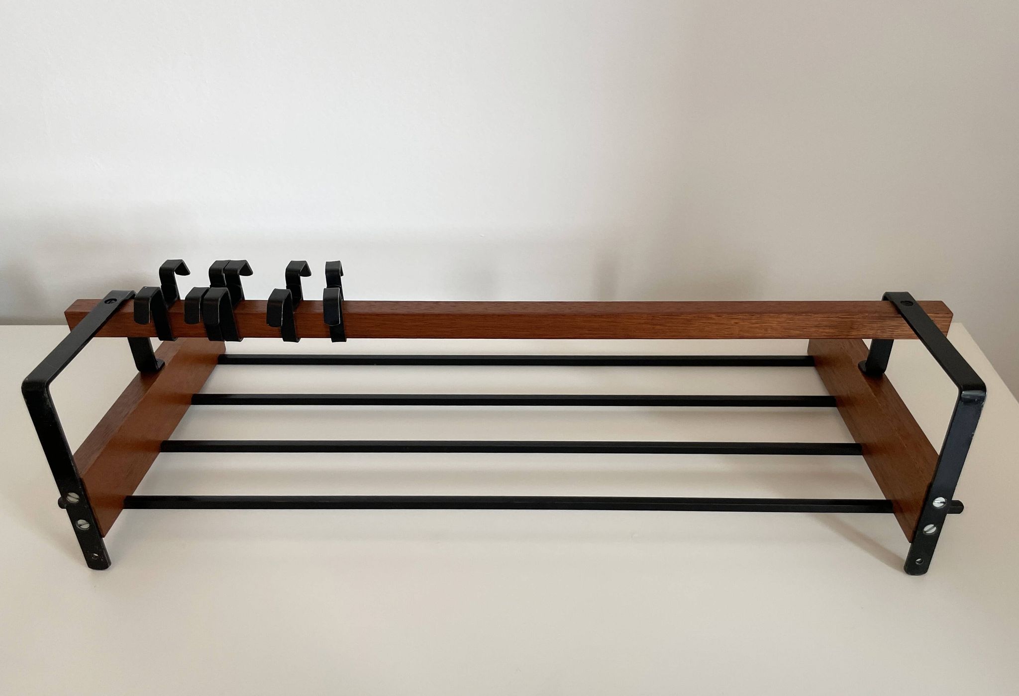 Vintage Scandinavian wall coat rack in wood and metal.