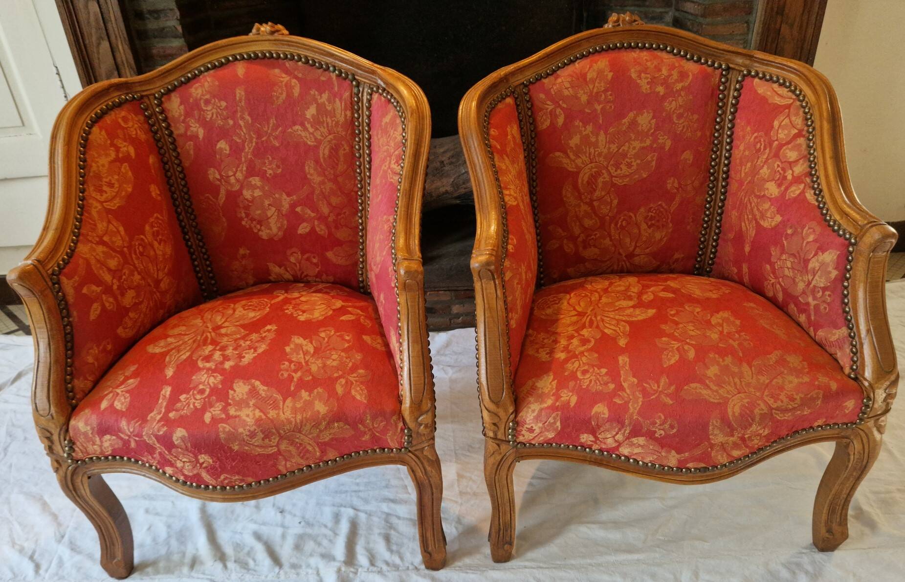 Pair of louis xv cabriolet armchairs with sculpted wood and pink & red floral fabric
