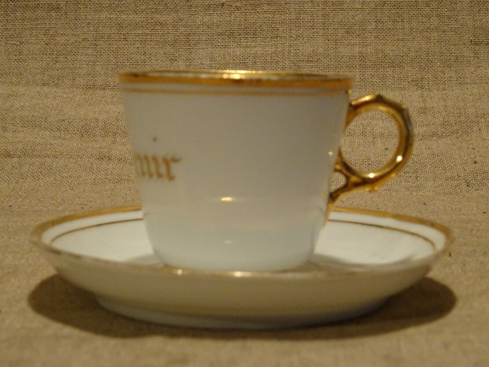 Old white and gold porcelain mocha cup marked souvenir