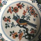 Wall plate in earthenware decorated with painting of flowers and bird 28 cm