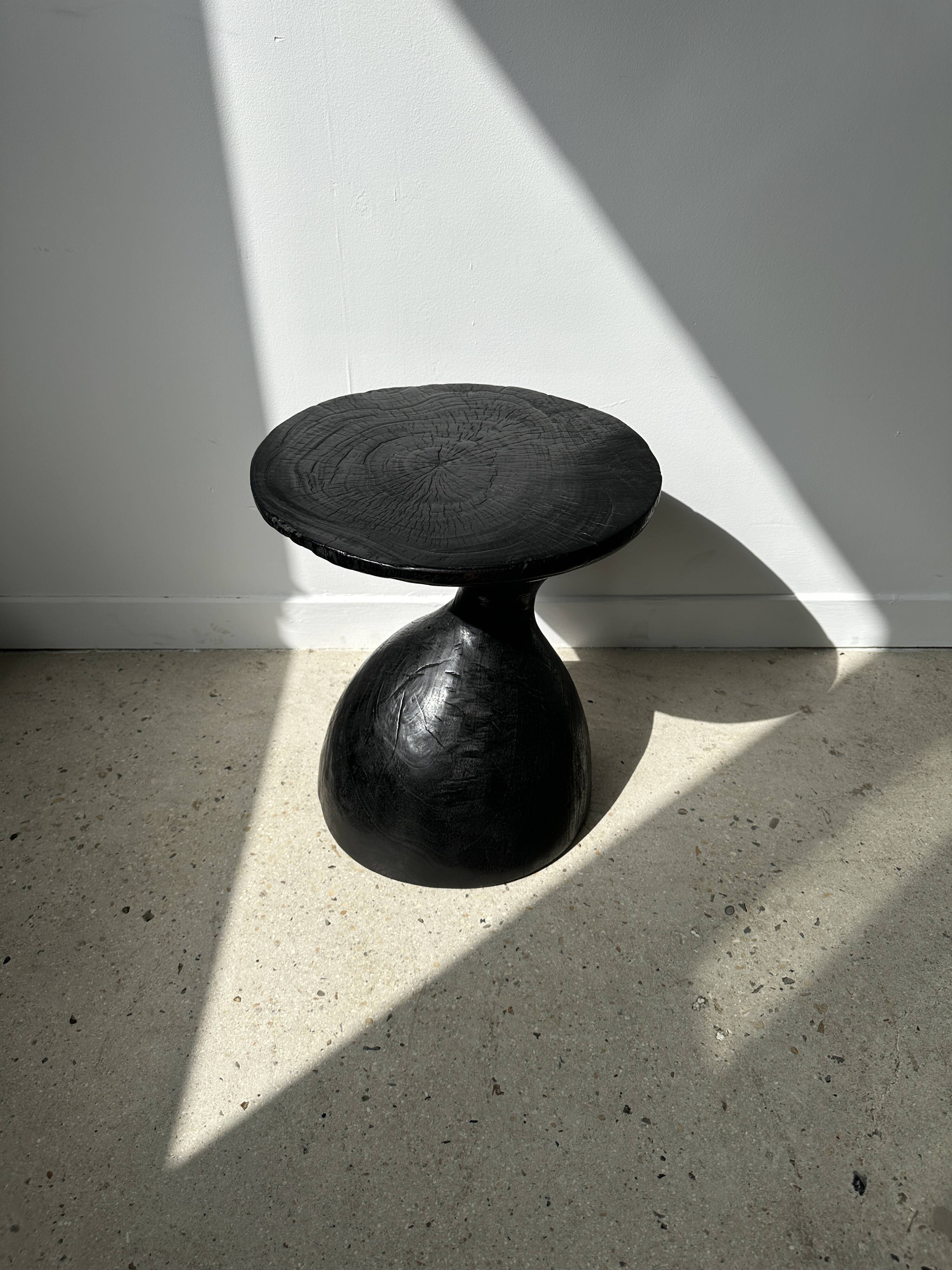 Solid wood (monoxyl) side table, organic shape, black color