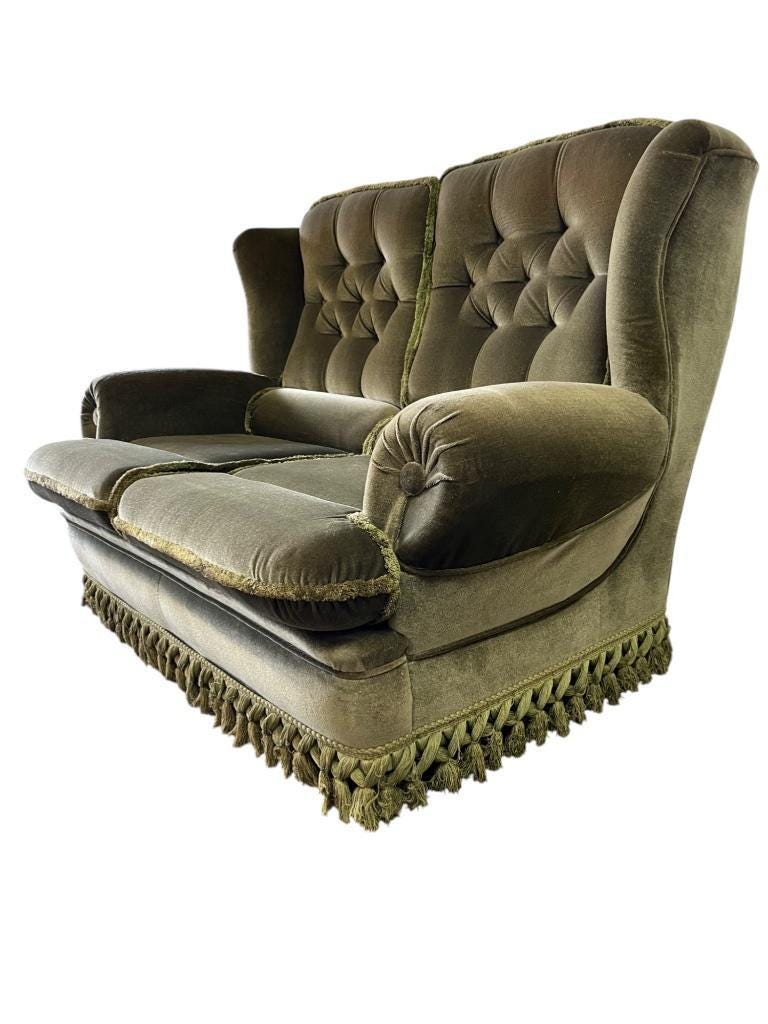 Vintage green two-seater sofa with fringes