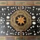 Blackened wood display table with marquetry top, Spain, 19th century.
