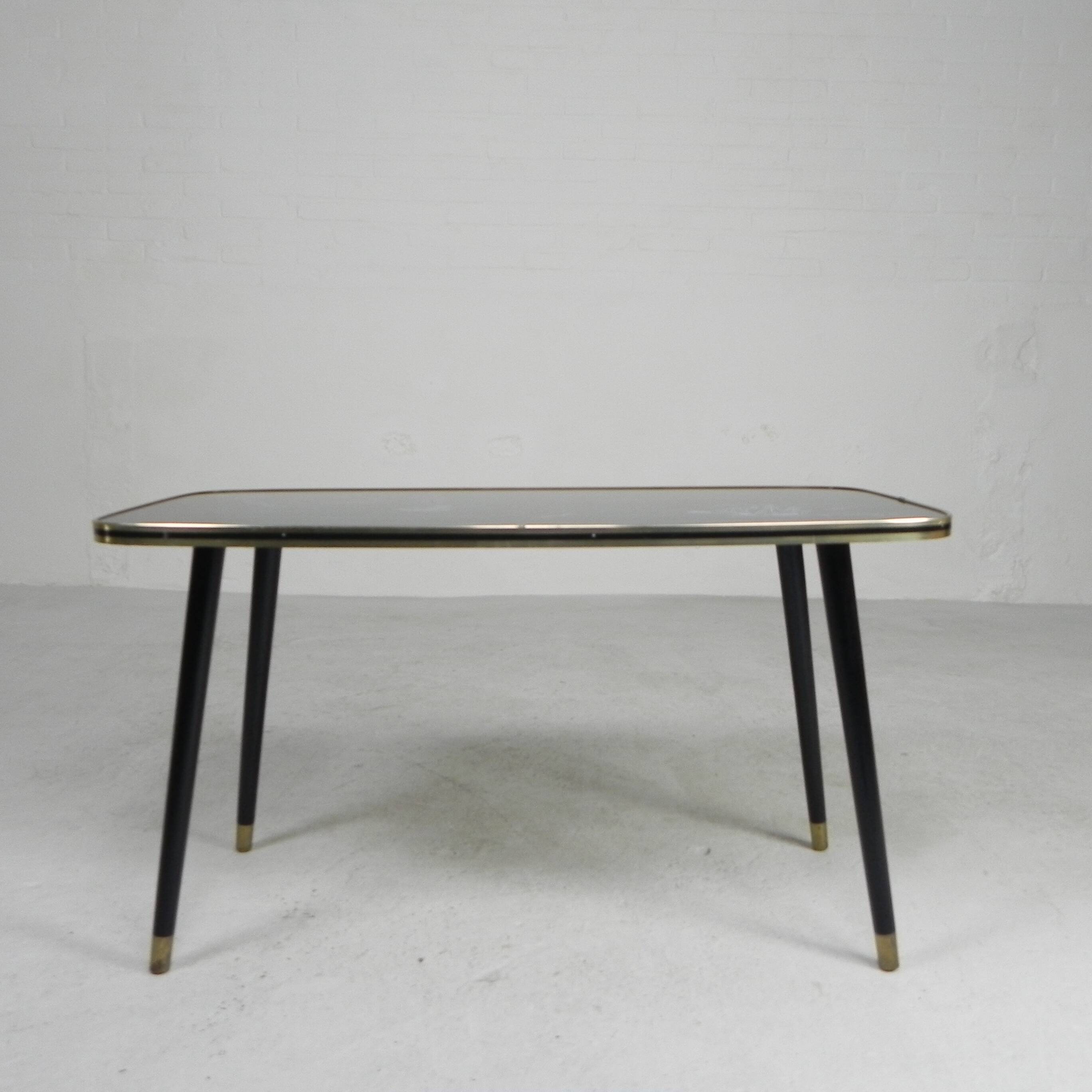 Vintage coffee table with glass top and angled legs