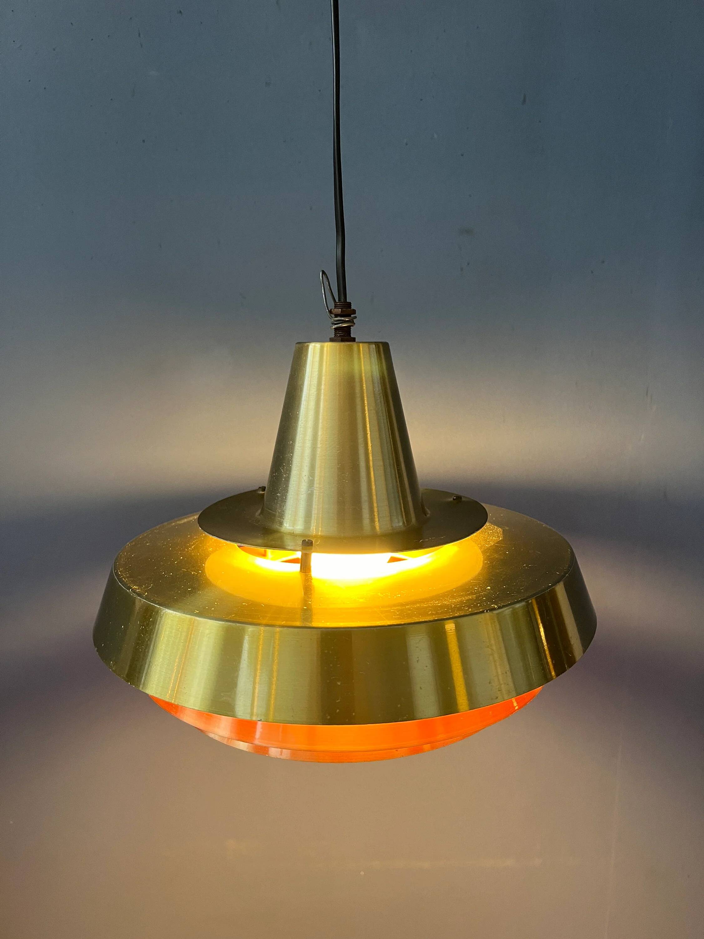 Mid-century Danish style orange brass suspension light.