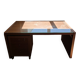 Large wooden desk with a glass top and a wheeled drawer unit.