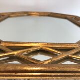 Octagonal mirror in gilded wood with closed guards