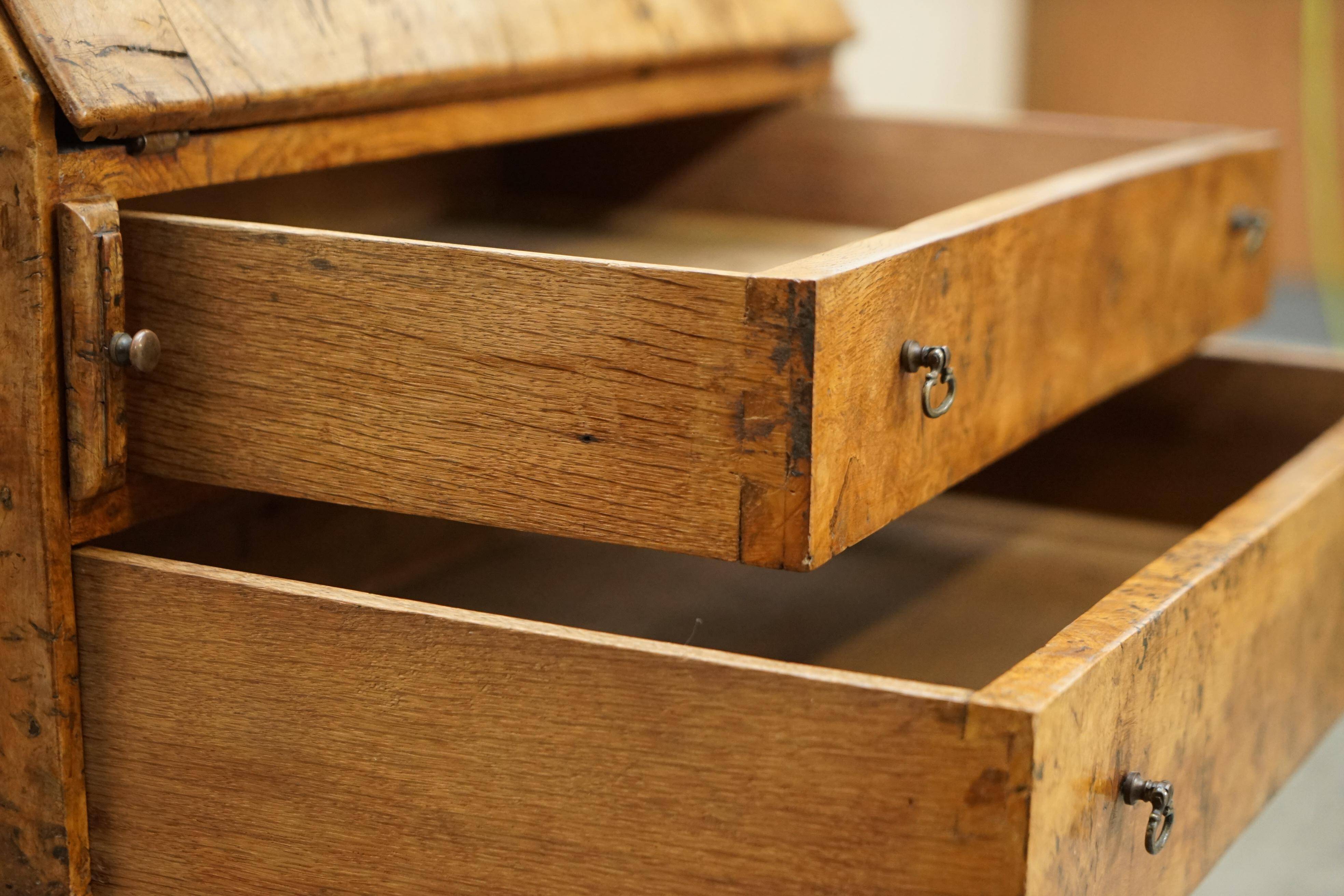 Writing desk in pollard oak from around 1800 with claw and ball carved legs.