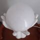 70s lamp two hands embrace an opaline globe