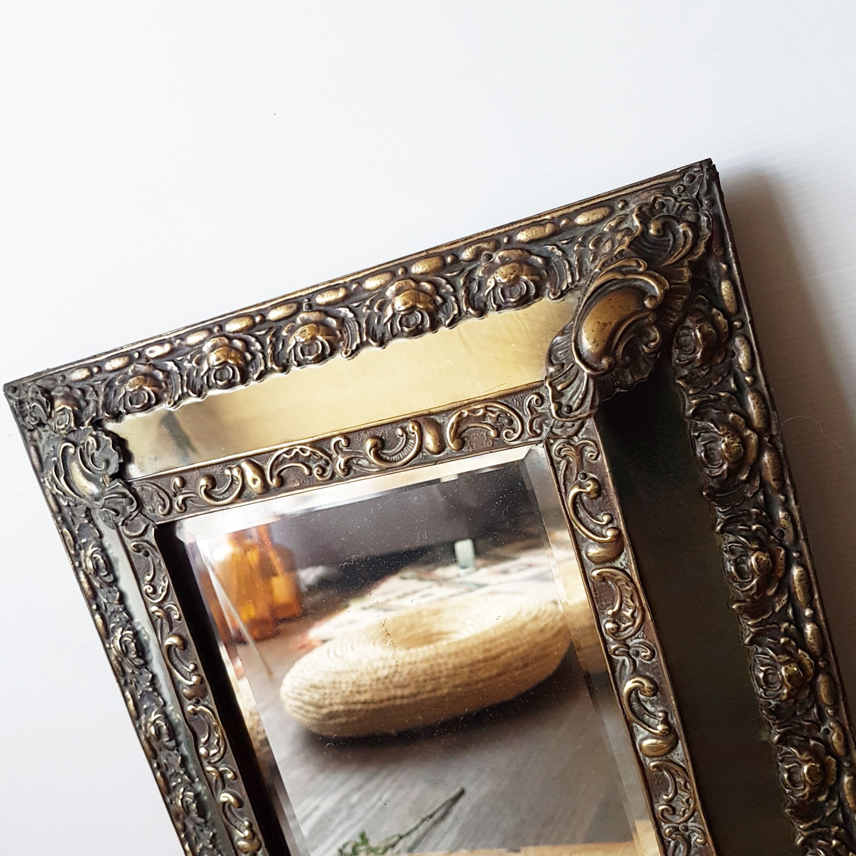 Old mirror made of wood and brass at the beginning of the 20th century