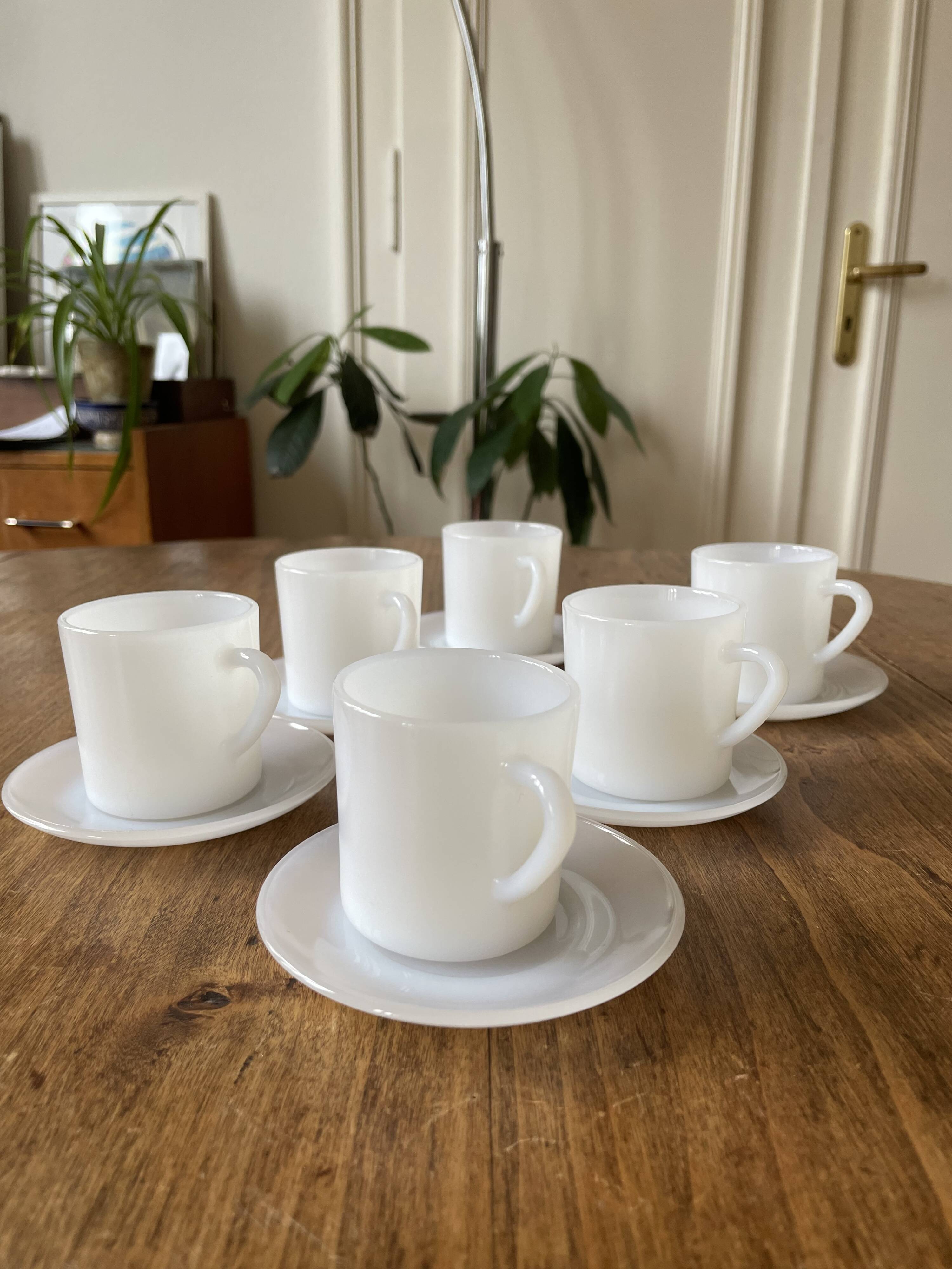 Espresso coffee cup service, Nestlé promotional items, in white glass.