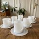 Espresso coffee cup service, Nestlé promotional items, in white glass.