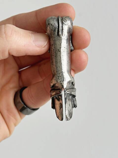 Antique metal knife rest in the shape of a dog.