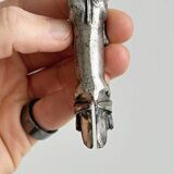 Antique metal knife rest in the shape of a dog.