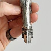 Antique metal knife rest in the shape of a dog.