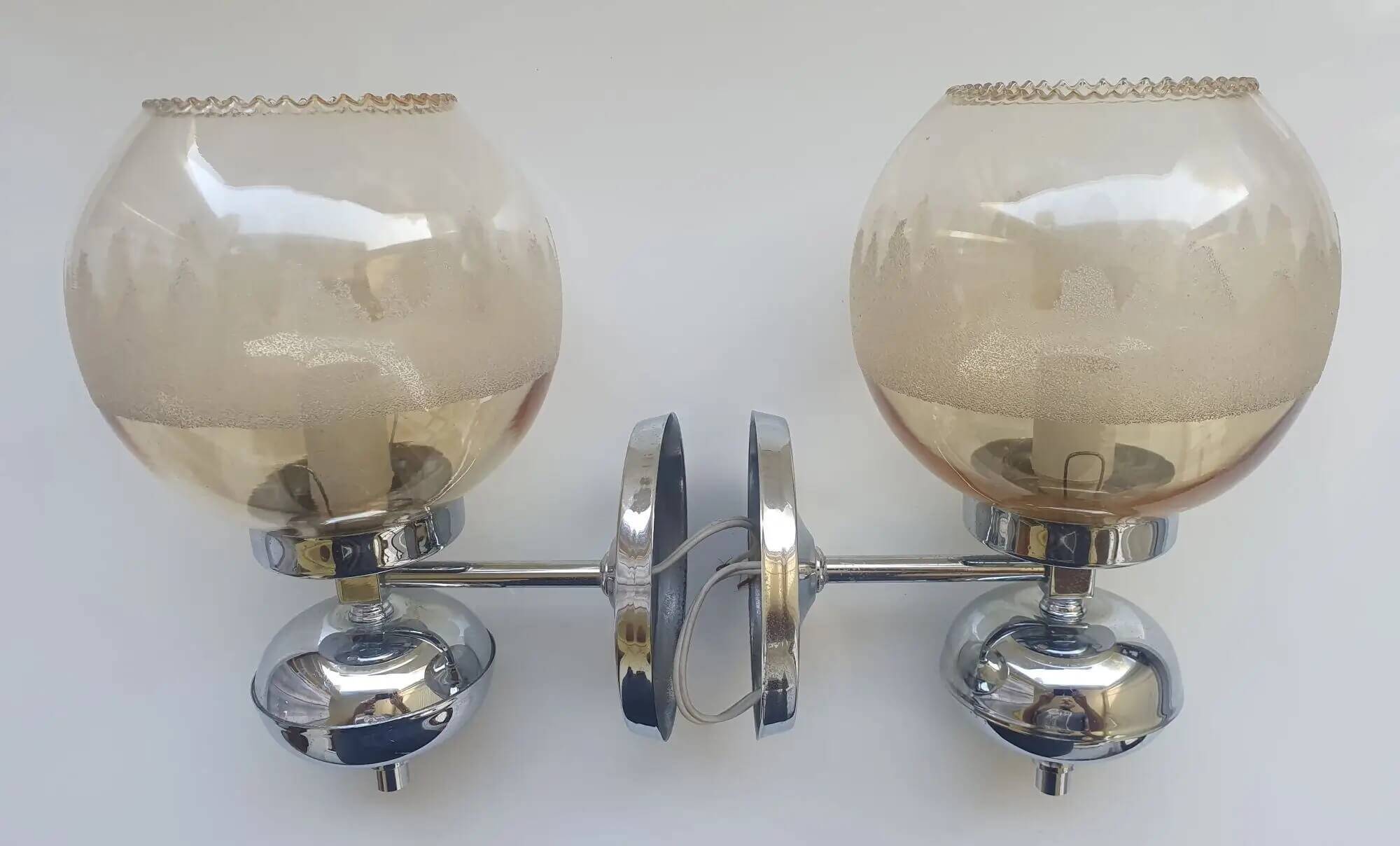 Pair of chrome metal wall lights with vintage sandblasted glass globes