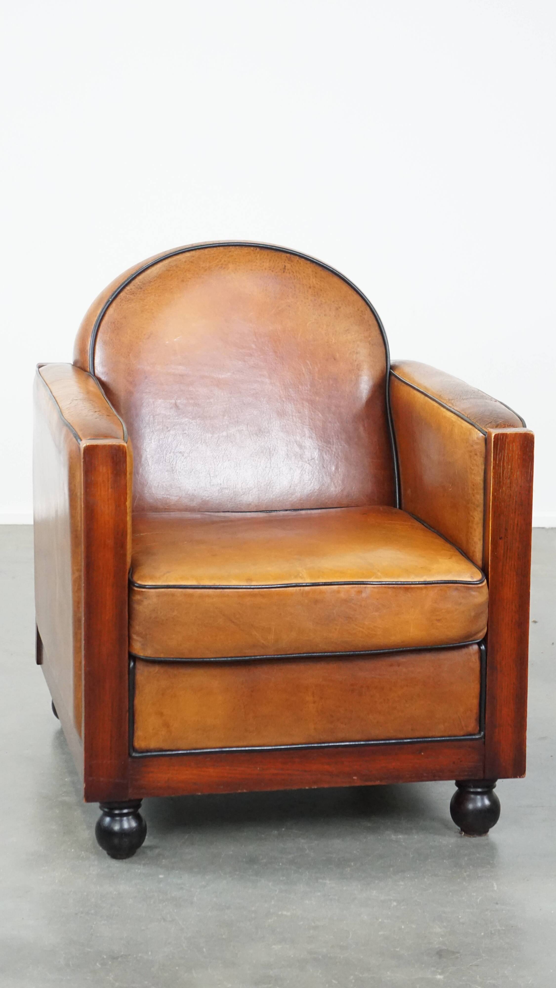 Sheep leather and wooden Art Deco design armchair with ball feet