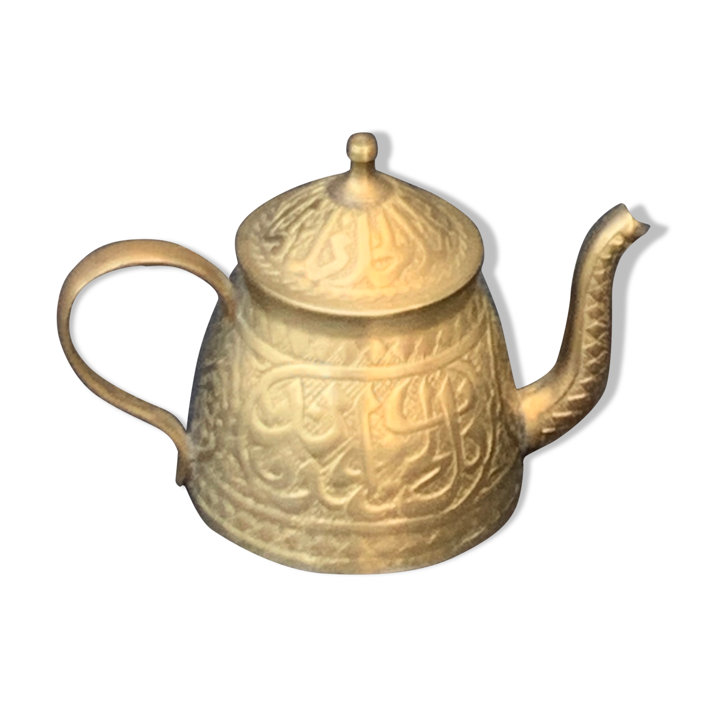Small decorative teapot in vintage chiseled copper