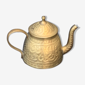 Small decorative teapot in vintage chiseled copper