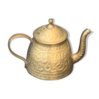 Small decorative teapot in vintage chiseled copper