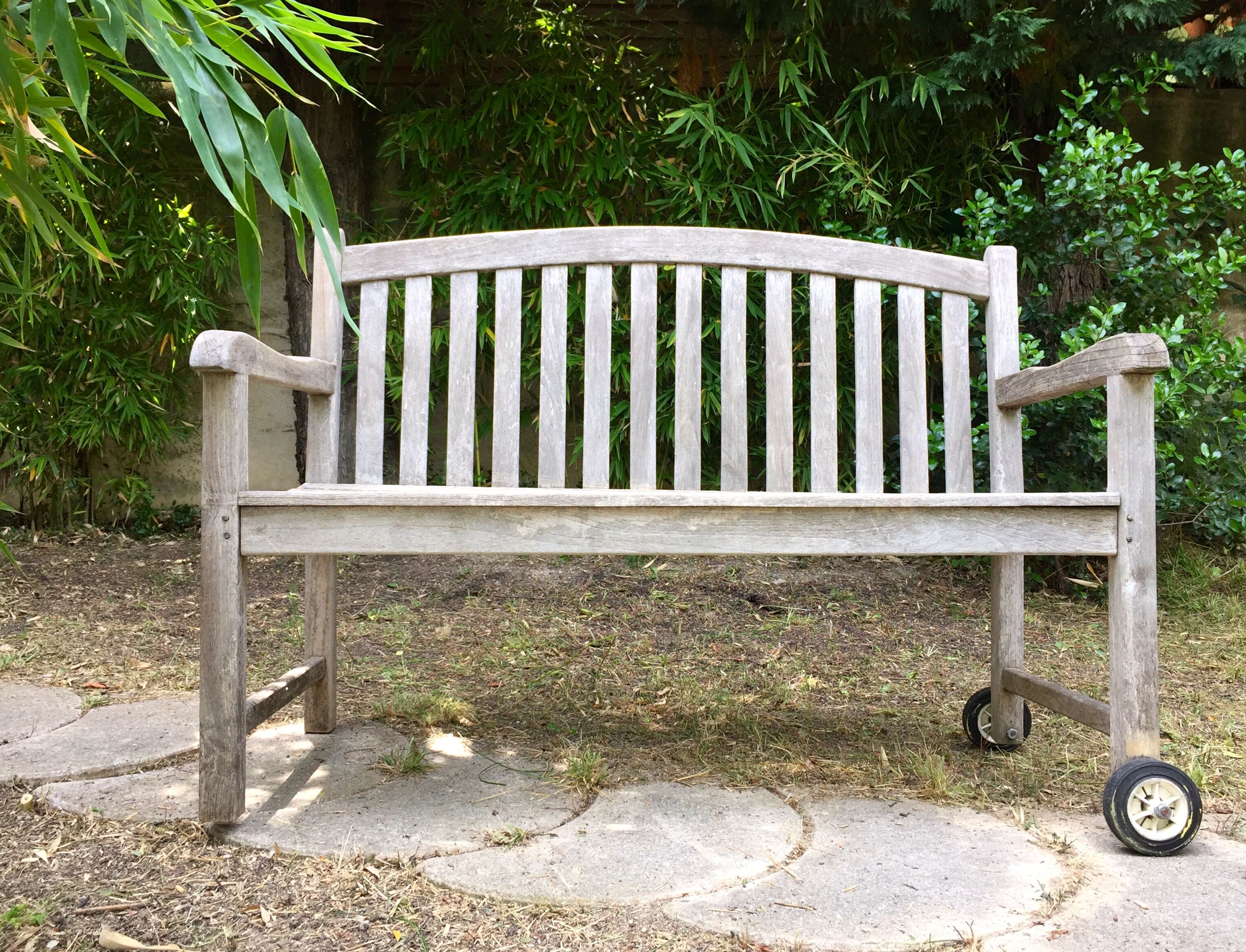 Vintage wooden garden bench with wheels