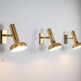 Set of three brass adjustable wall lamps
