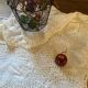 White cotton tablecloth with crochet lace.