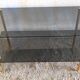 Coffee table in gilded metal and smoked glass – 60s