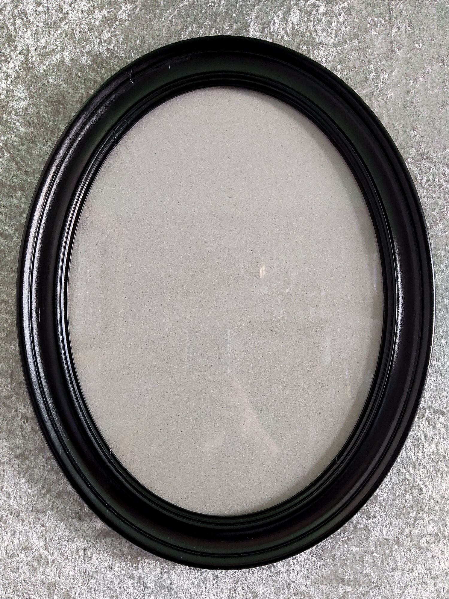 Oval frame in black varnished wood