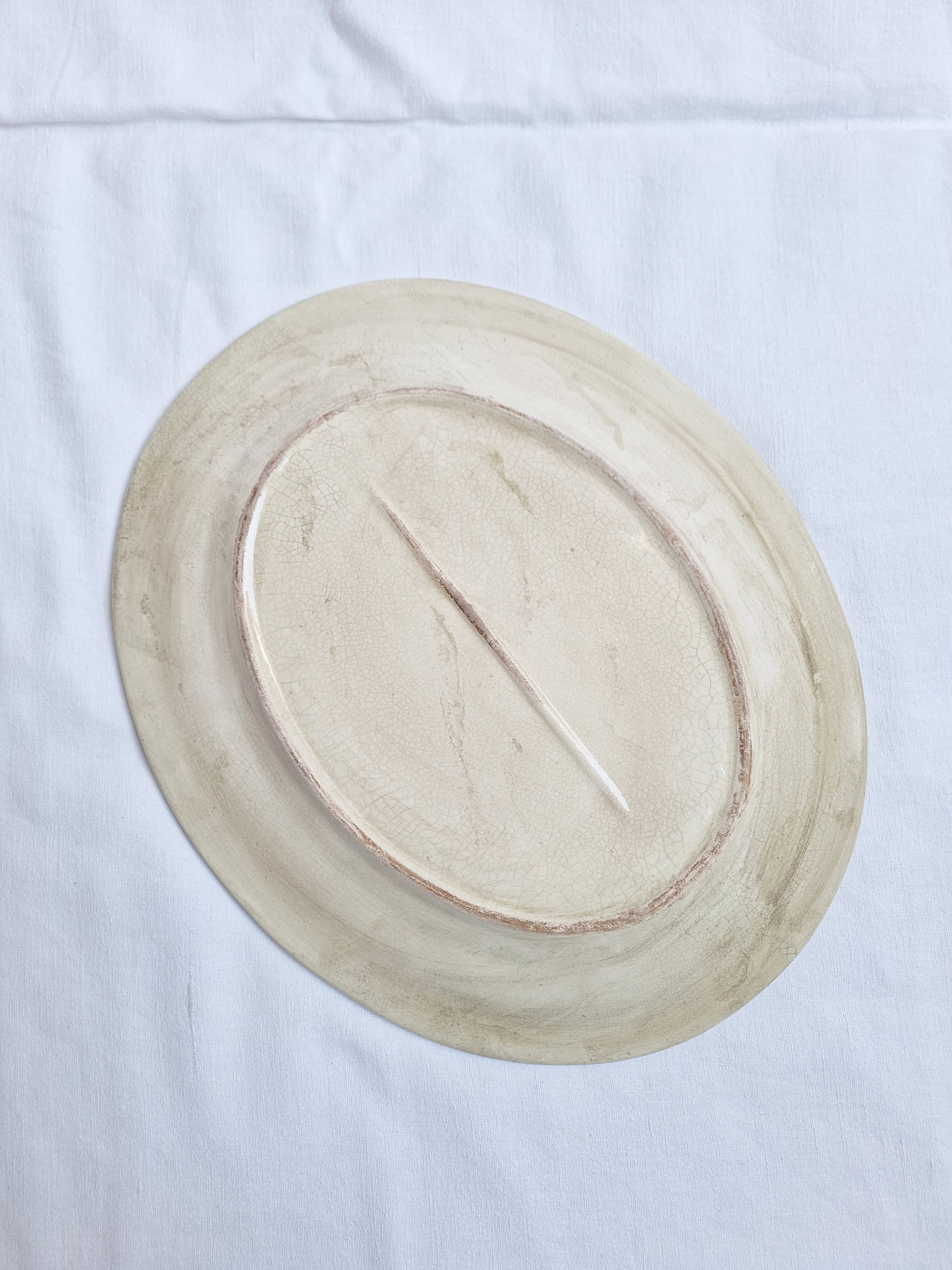 Oval plate, hand-painted meat platter in orange and green.