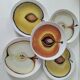 5 hand-painted dessert plates, decorated with stylised fruits.