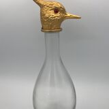 Glass bottle type carafe with gold metal bird head stopper
