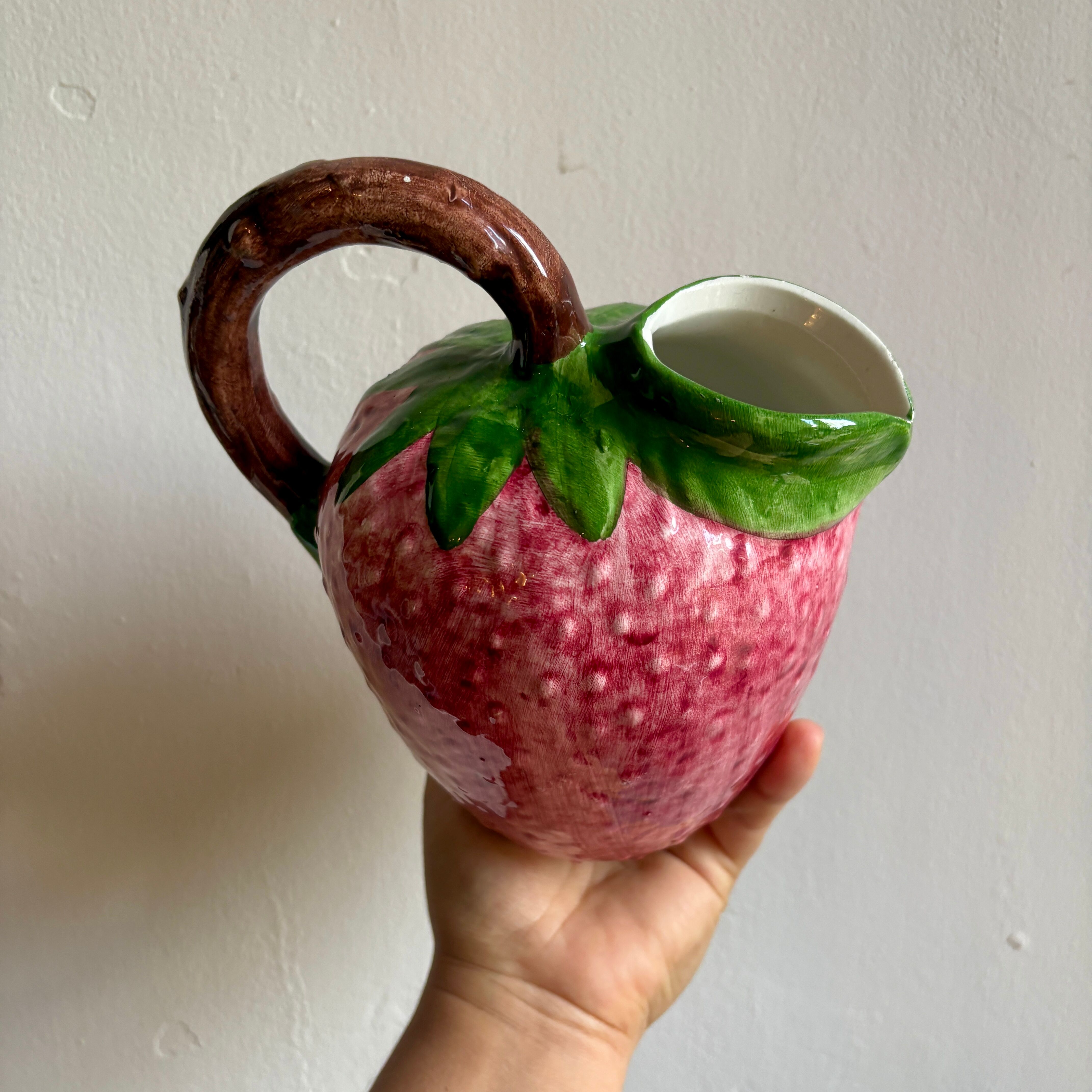 Ceramic jug in the shape of a strawberry.