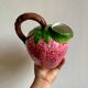 Ceramic jug in the shape of a strawberry.