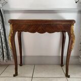 Console transforming into a 19th century Louis XV style gaming table