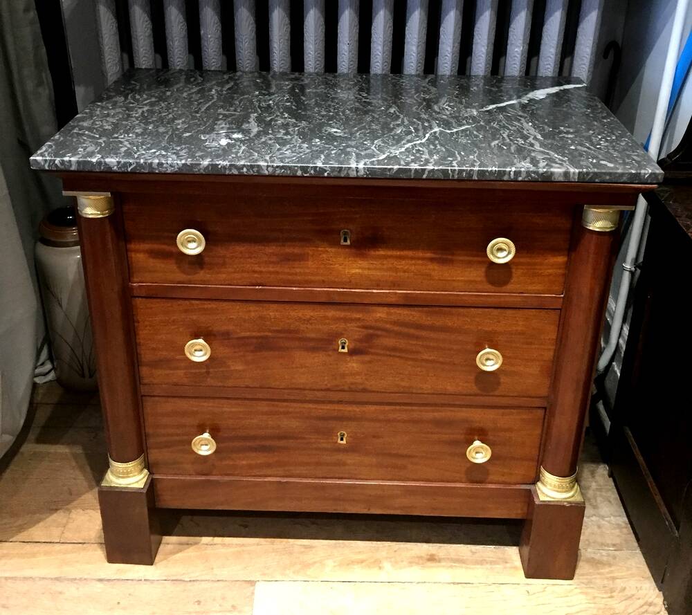 Empire chest of drawers with half columns in mahogany and gilded bronze