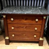 Empire chest of drawers with half columns in mahogany and gilded bronze