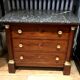 Empire chest of drawers with half columns in mahogany and gilded bronze