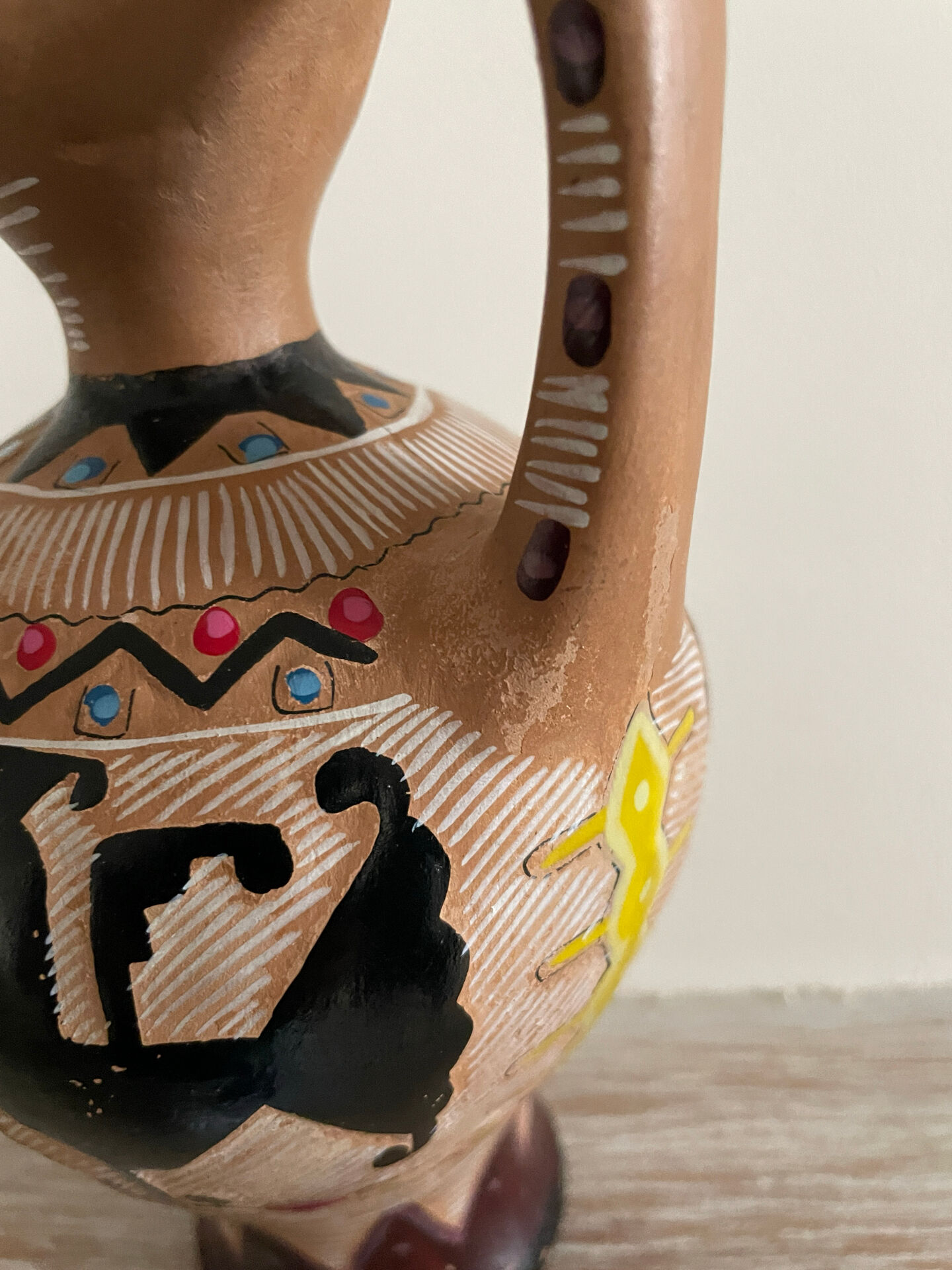 Clay pitcher with a bird head