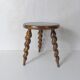 old tripod stool plant holder in turned wood