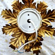 Vintage floral metal applique in gold.