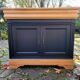 Cherry and black sideboard with 2 doors and 1 drawer.